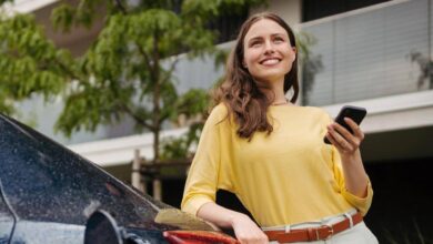 Woman smiling while charging her electric vehicle