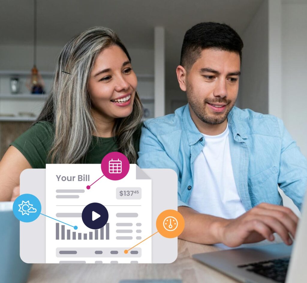 Couple smiling while looking at utility bill and laptop