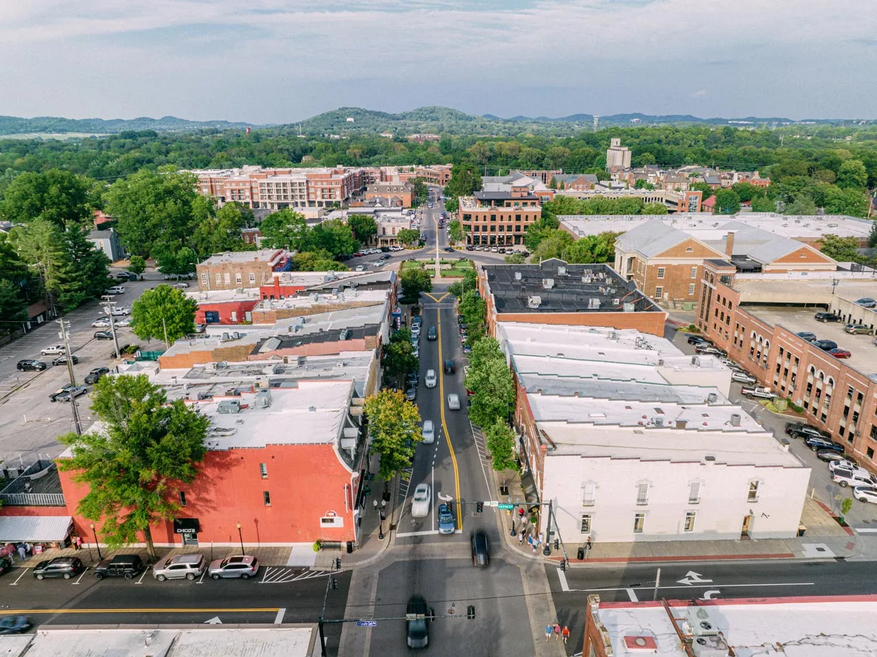 Aerial view of a city's main street with buildings and businesses on either side.