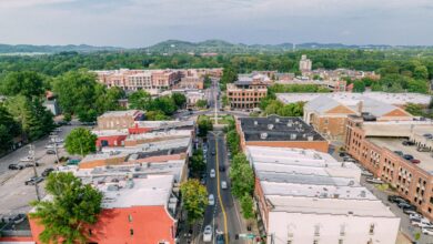 Aerial view of a city's main street with buildings and businesses on either side.