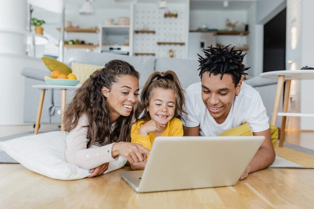 Young happy family using laptop at home