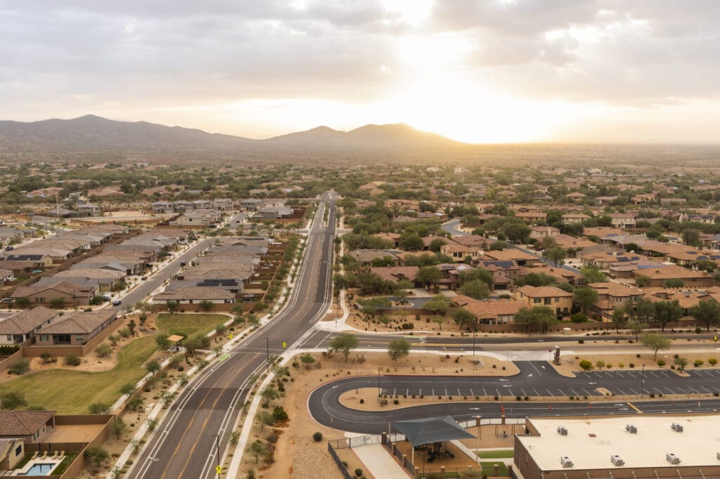 Aerial View Landscape Of Road And Mountain Buttes, Residential Area In Phoenix, Arizona On Orange Sunrise Or Sunset Sky. Arizona. National Arizona Day, June 21 Beautiful Hills, Scenic Landscape.