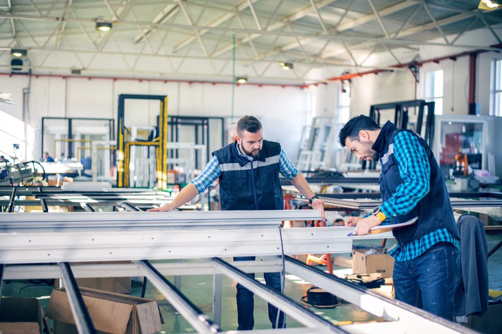 Two industrial employees working in facility